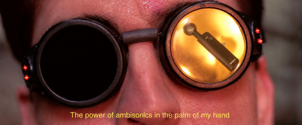 Doc Ock wearing goggles with a Sony ECM-AX10 reflected in the bright lens, captioned The power of ambisonics in the palm of my hand.